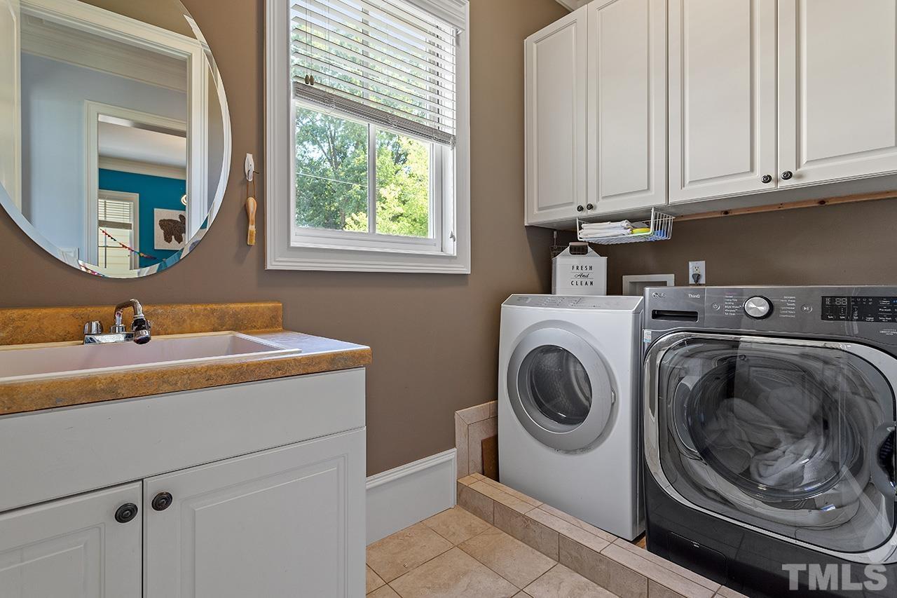 3100 Raymond Street Raleigh, NC 27607 - Photo 30 of 37 a utility room with sink dryer and washer