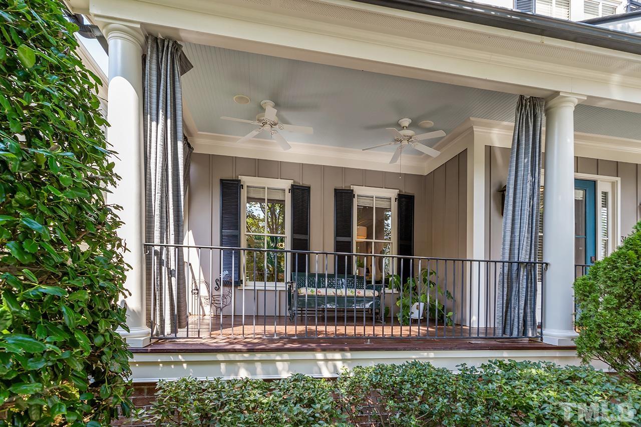3100 Raymond Street Raleigh, NC 27607 - Photo 3 of 37 a view of a house with a small yard and floor to ceiling window and potted plants