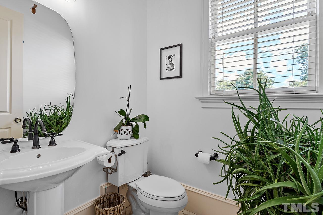 3100 Raymond Street Raleigh, NC 27607 - Photo 31 of 37 a bathroom with a sink a toilet and a mirror