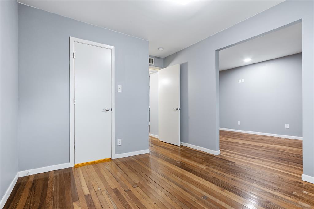 1804 Gould Street, Unit 9 Dallas, TX 75215 - Photo 5 of 12 a view of an empty room with wooden floor and entryway