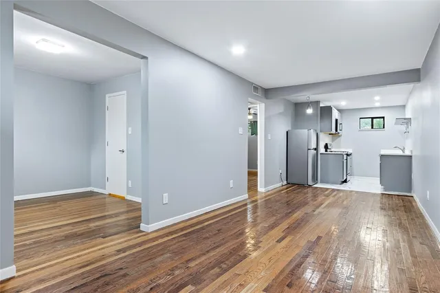 a view of a kitchen with wooden floor and a kitchen
