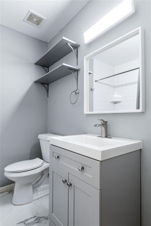 1804 Gould Street, Unit 9 Dallas, TX 75215 - Photo 9 of 12 a bathroom with a sink a toilet and a mirror