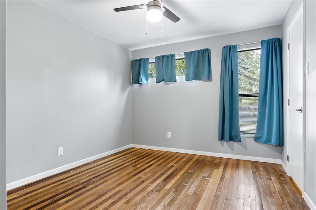 1804 Gould Street, Unit 9 Dallas, TX 75215 - Photo 10 of 12 wooden floor in an empty room with a window