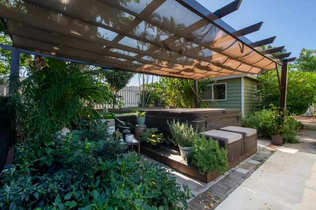 a view of a patio with table and chairs and potted plants