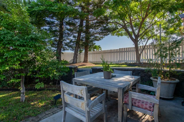 a view of backyard with outdoor seating and green space