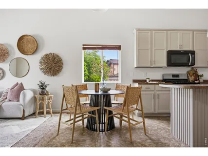 a dining room with furniture and a window