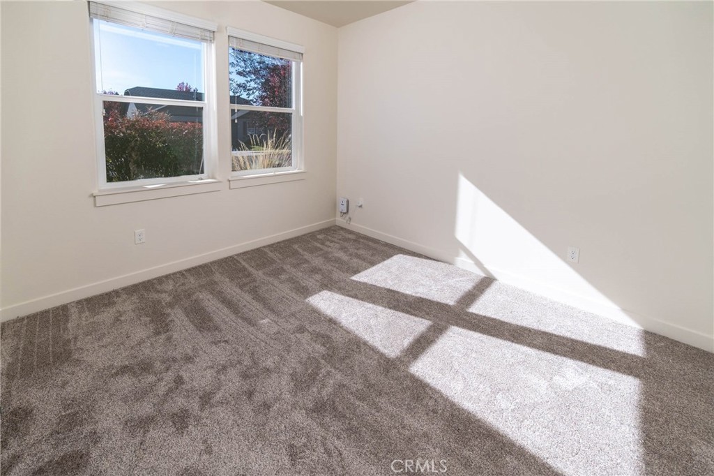 3667 Southwest Pumice Stone Avenue Redmond, OR 97756 - Photo 12 of 13 a view of an empty room with wooden floor and a window