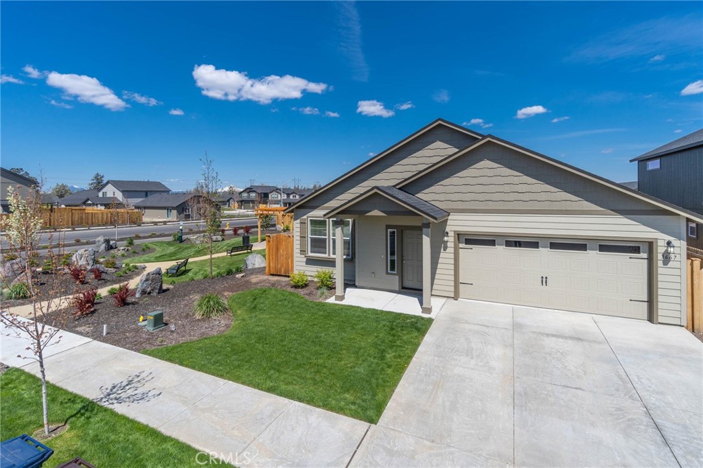 3667 Southwest Pumice Stone Avenue Redmond, OR 97756 - Photo 3 of 13 a front view of a house with a yard and garage