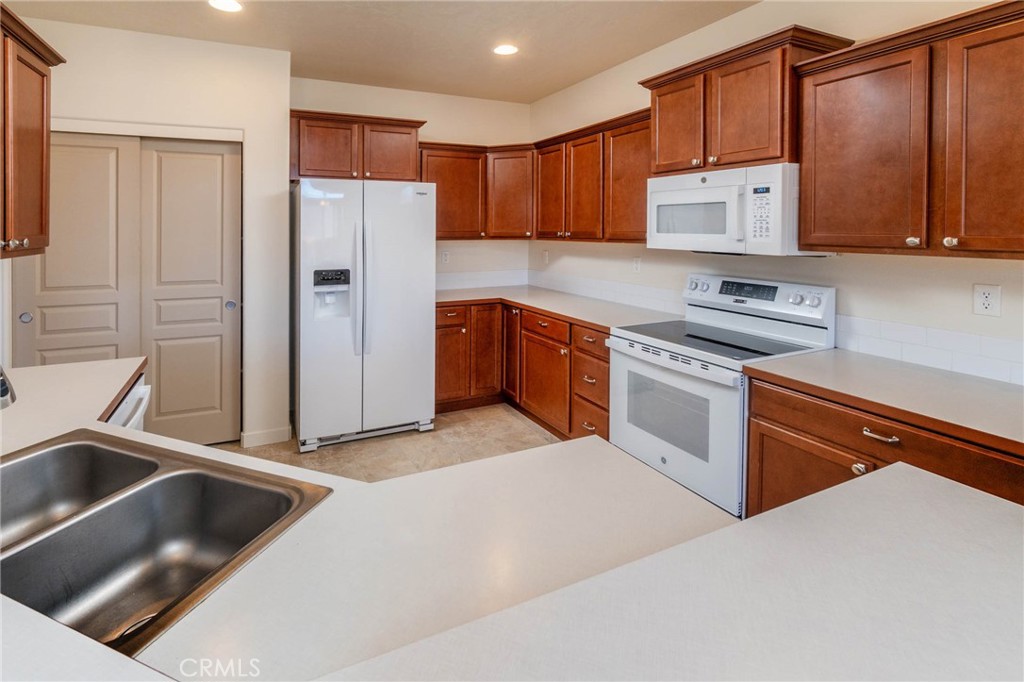 3667 Southwest Pumice Stone Avenue Redmond, OR 97756 - Photo 6 of 13 a kitchen with stainless steel appliances granite countertop a refrigerator sink and cabinets