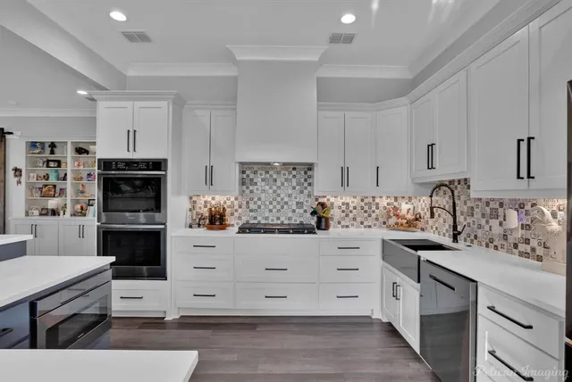 a dining room with stainless steel appliances kitchen island granite countertop a dining table chairs and a oven