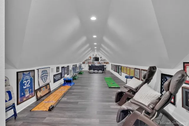 a work room with furniture and a flat screen tv