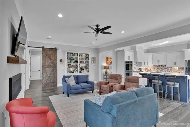 a living room with furniture kitchen view and a fireplace