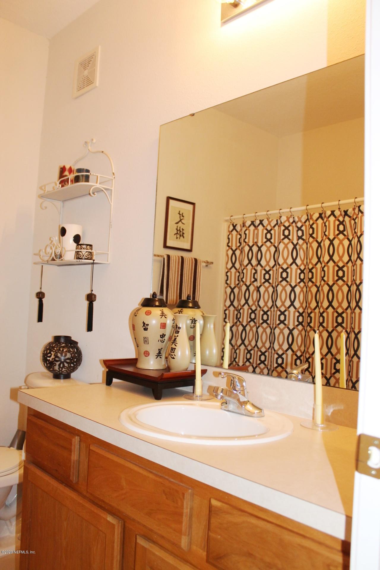 3680 Kirkpatrick Circle, Unit 3 Jacksonville, FL 32210 - Photo 9 of 29 a bathroom with a sink and a mirror