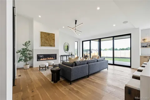a living room with furniture large window and a fireplace