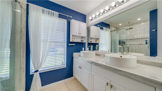 a bathroom with a sink double vanity and a mirror