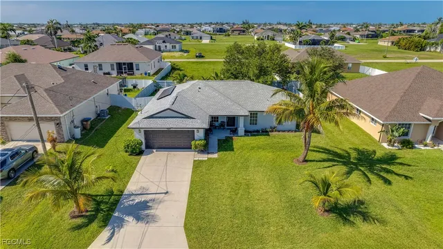 a view of house with garden space and swimming pool