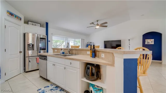 a kitchen with stainless steel appliances a sink stove and refrigerator