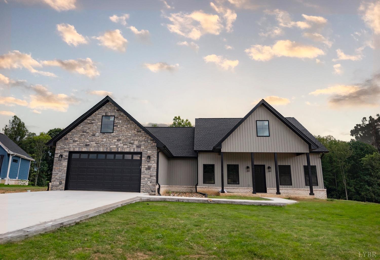 a front view of a house with a garden and yard