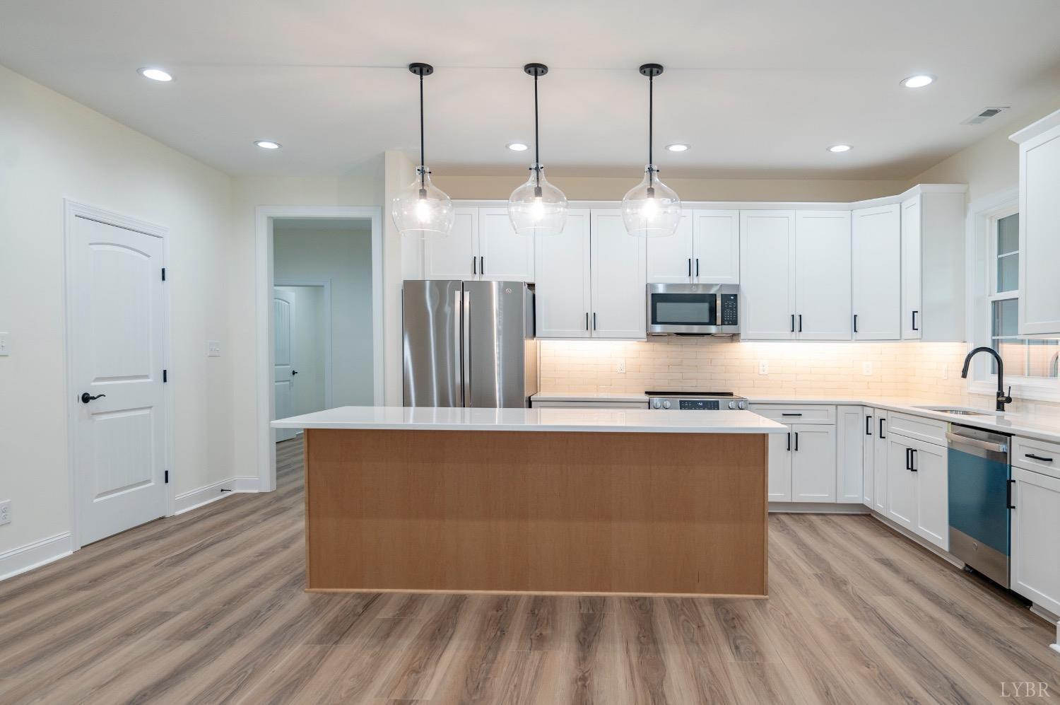 1738 Willow Oak Drive Forest, VA 24551 - Photo 11 of 54 a large kitchen with stainless steel appliances granite countertop a granite counter tops and a wooden floors