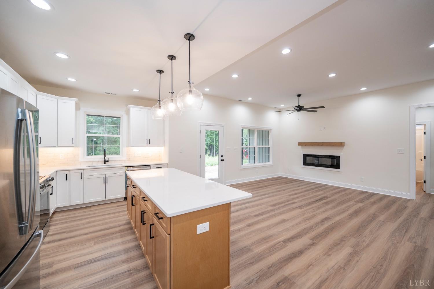1738 Willow Oak Drive Forest, VA 24551 - Photo 17 of 54 a kitchen with a sink wooden floor cabinetry and a refrigerator