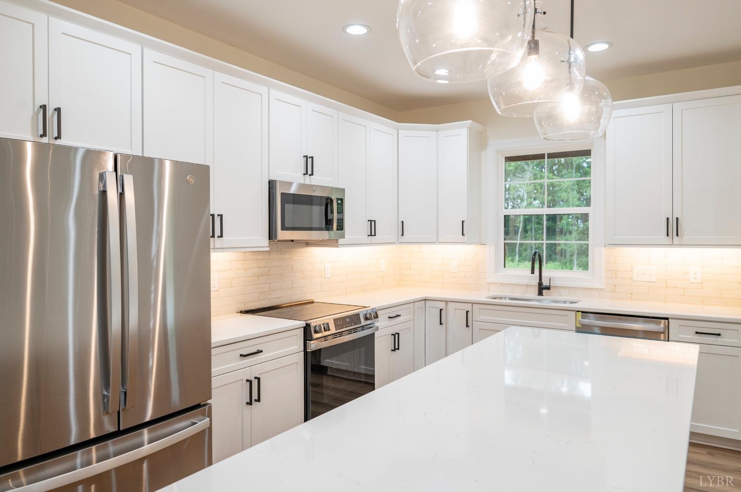 1738 Willow Oak Drive Forest, VA 24551 - Photo 21 of 54 a kitchen with stainless steel appliances a refrigerator sink and microwave