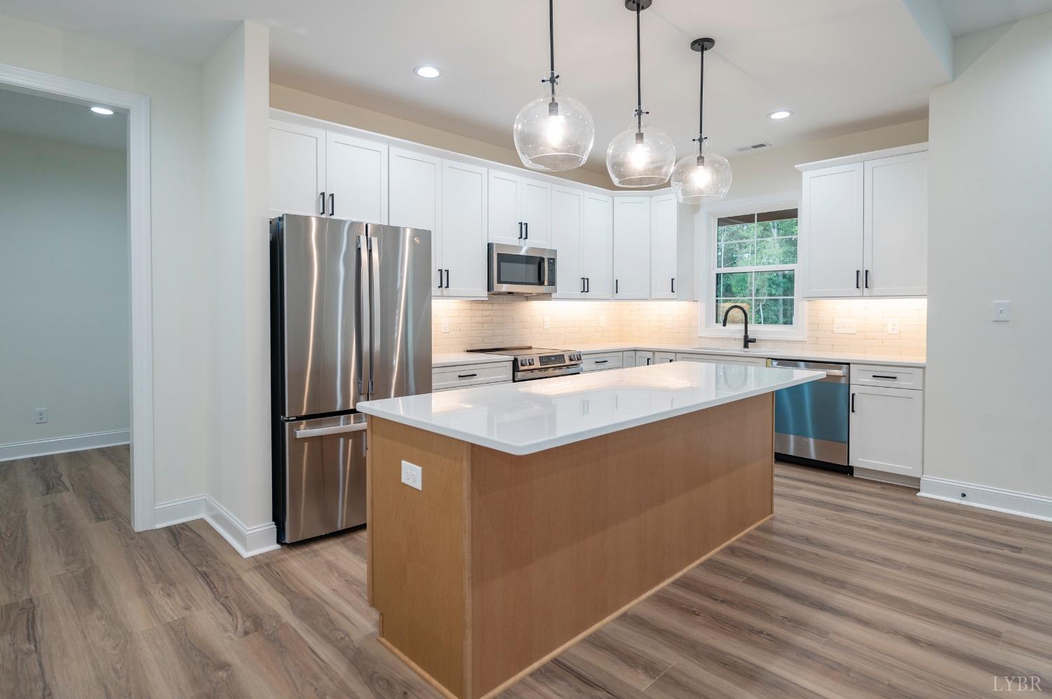 1738 Willow Oak Drive Forest, VA 24551 - Photo 6 of 54 a kitchen with kitchen island a counter top space a sink appliances and cabinets
