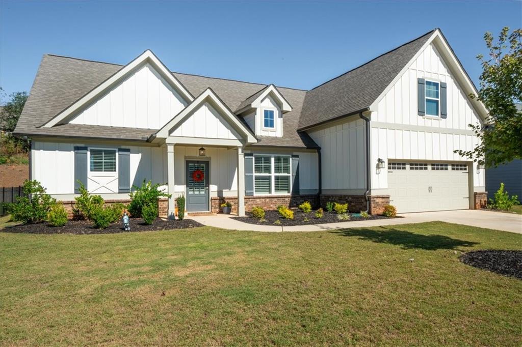 a front view of a house with a yard and outdoor seating