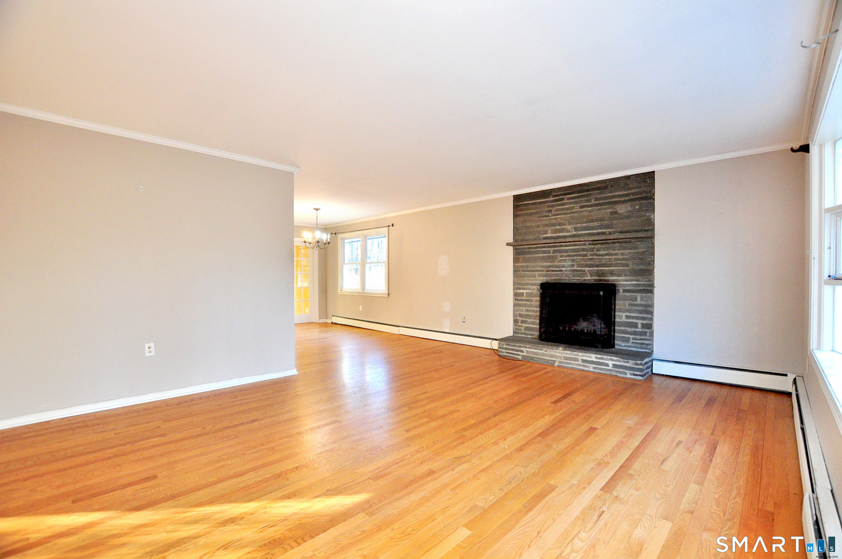204 Goodhouse Road Litchfield, CT 06759 - Photo 11 of 37 a view of empty room with wooden floor and fireplace
