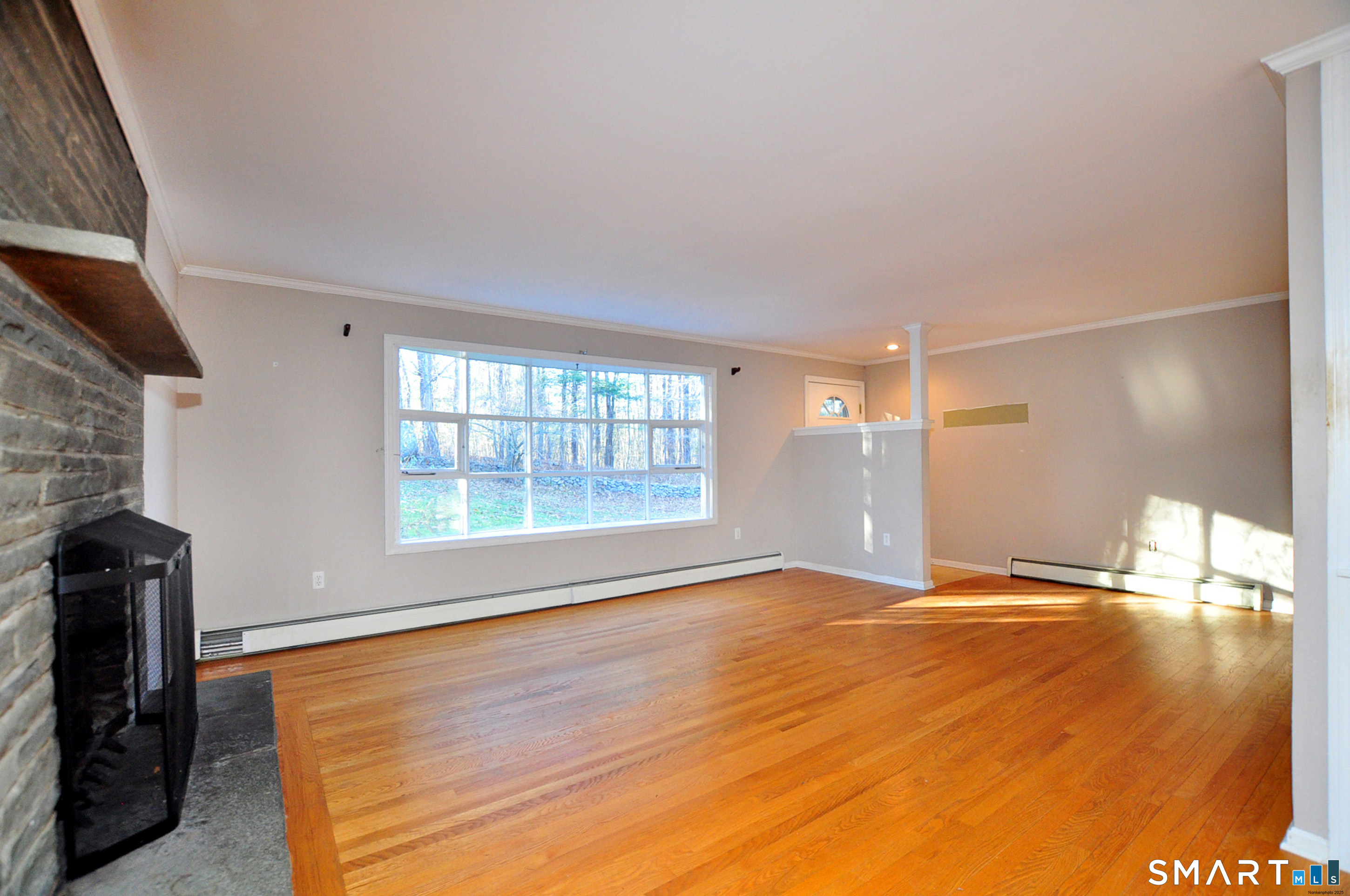 204 Goodhouse Road Litchfield, CT 06759 - Photo 12 of 37 a view of an empty room with a window and wooden floor