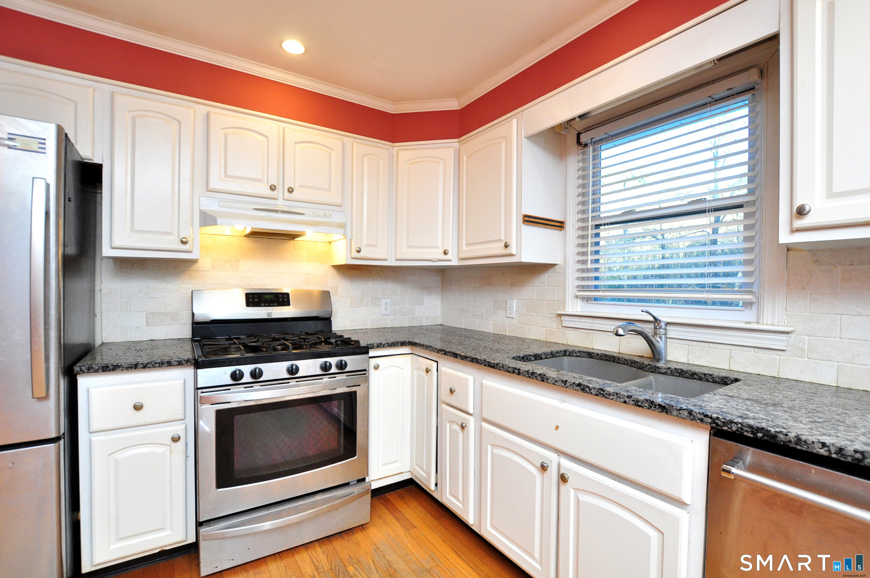 204 Goodhouse Road Litchfield, CT 06759 - Photo 15 of 37 a kitchen with granite countertop wooden floor stainless steel appliances a sink and a window
