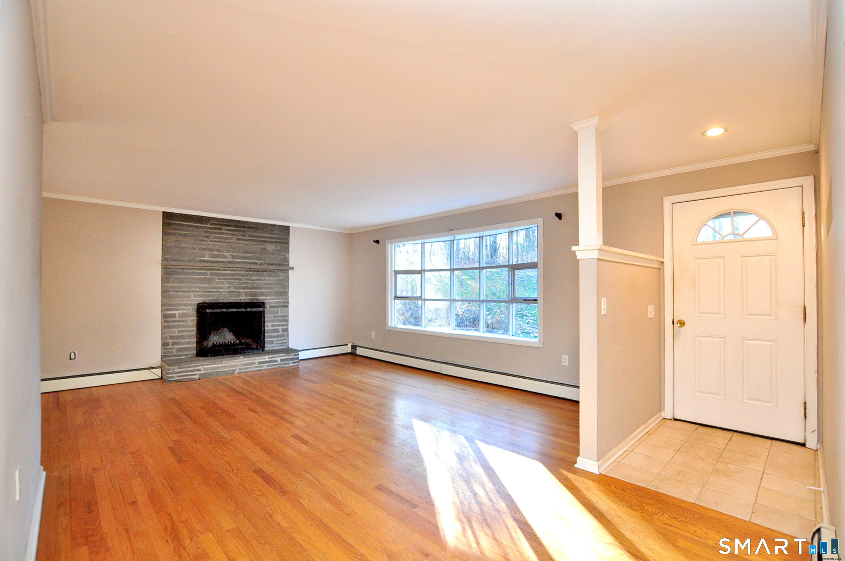 204 Goodhouse Road Litchfield, CT 06759 - Photo 3 of 37 a view of an empty room with a window and fireplace