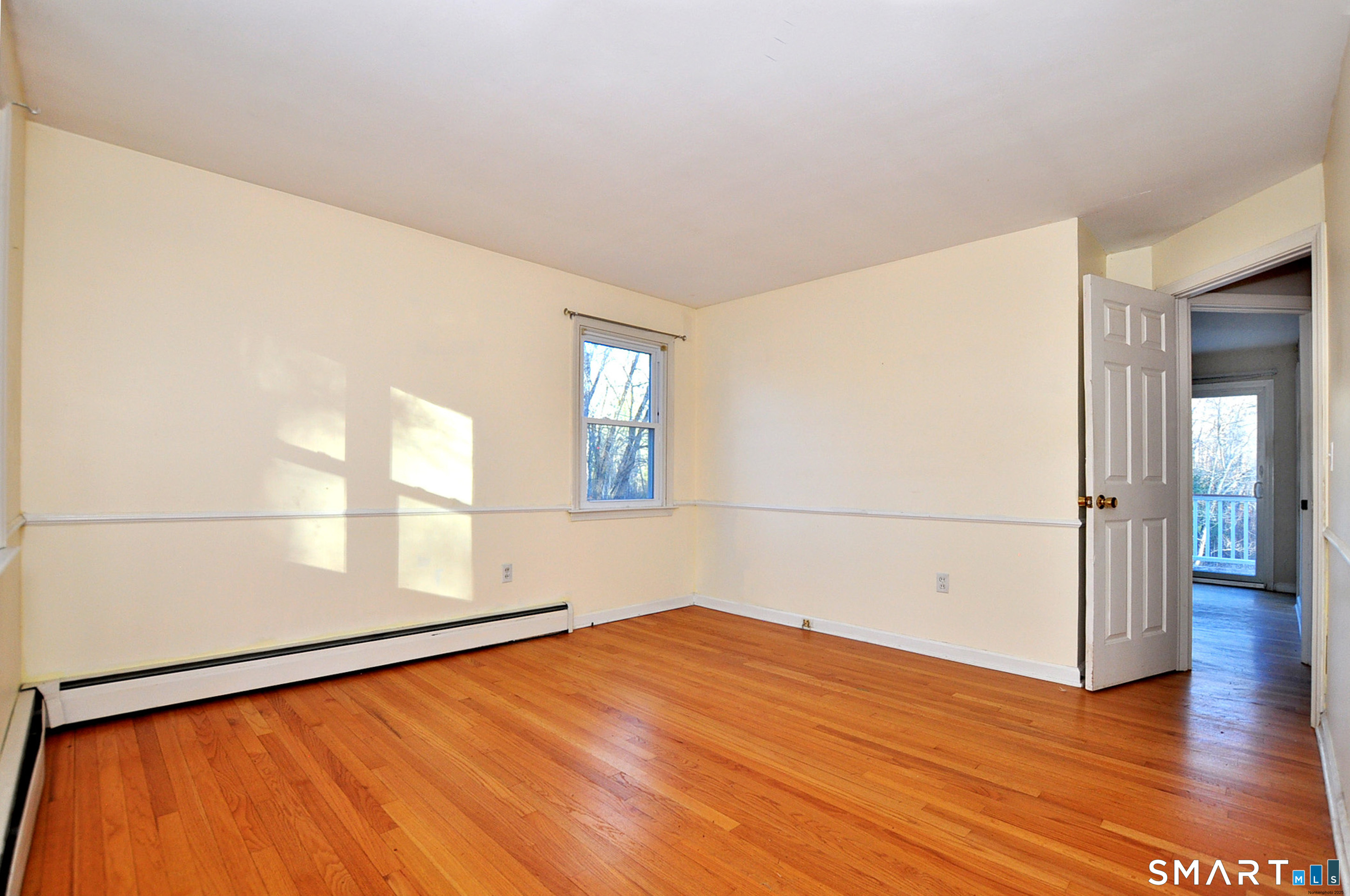 204 Goodhouse Road Litchfield, CT 06759 - Photo 32 of 37 an empty room with wooden floor and windows