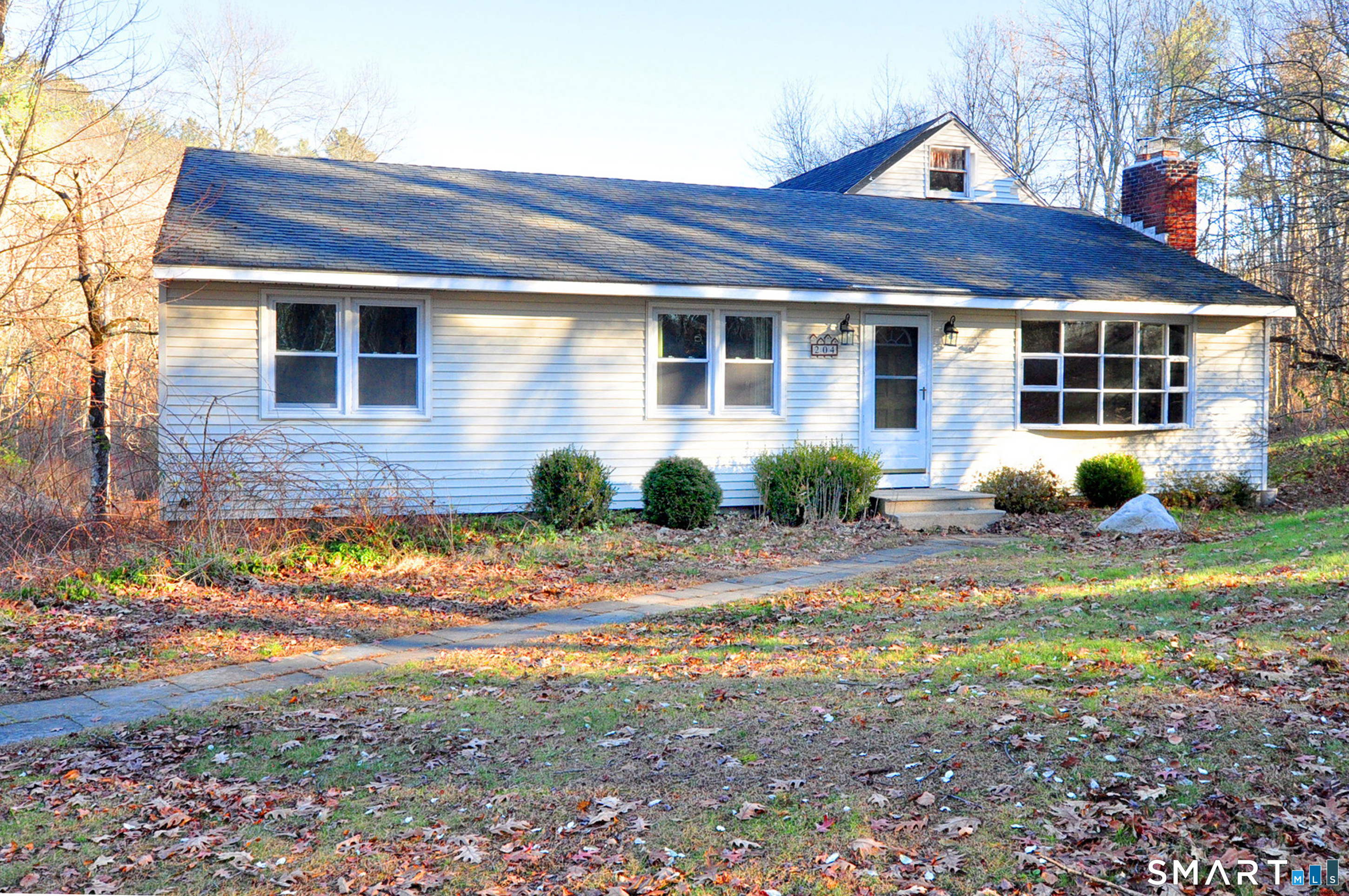 204 Goodhouse Road Litchfield, CT 06759 - Photo 6 of 37 a front view of a house with a yard and potted plants