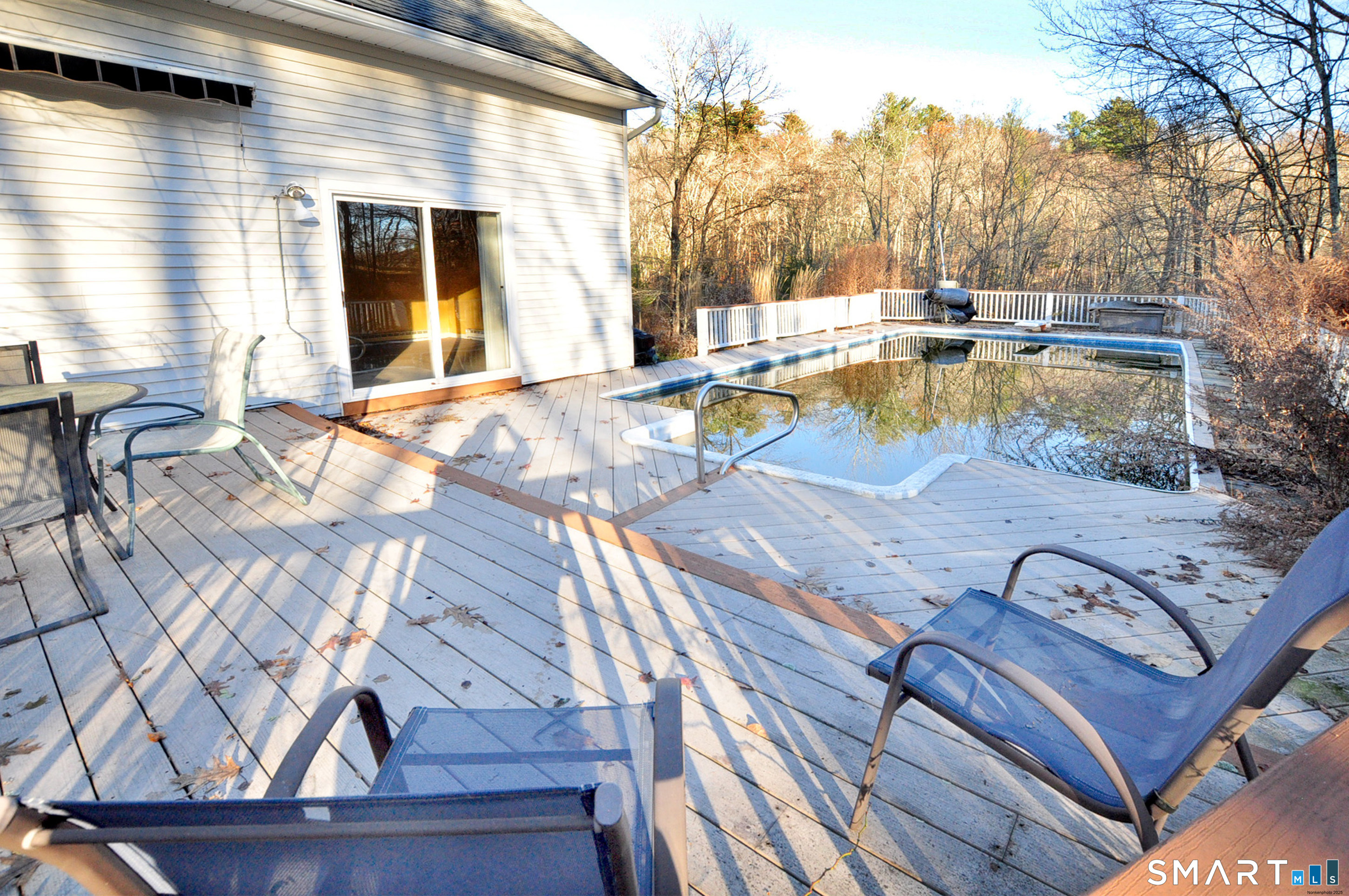 204 Goodhouse Road Litchfield, CT 06759 - Photo 8 of 37 a view of a patio with couches chairs and a dining table under an umbrella