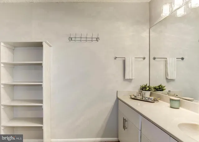 a bathroom with a double vanity sink mirror and toilet