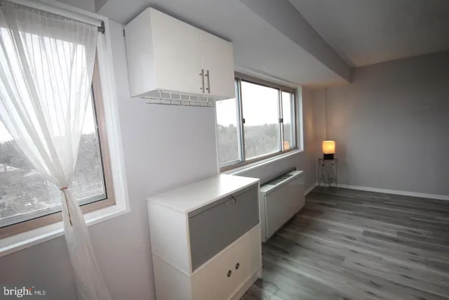 a kitchen with granite countertop a sink a stove and refrigerator