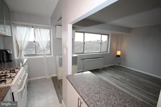 a kitchen with white cabinets and white appliances