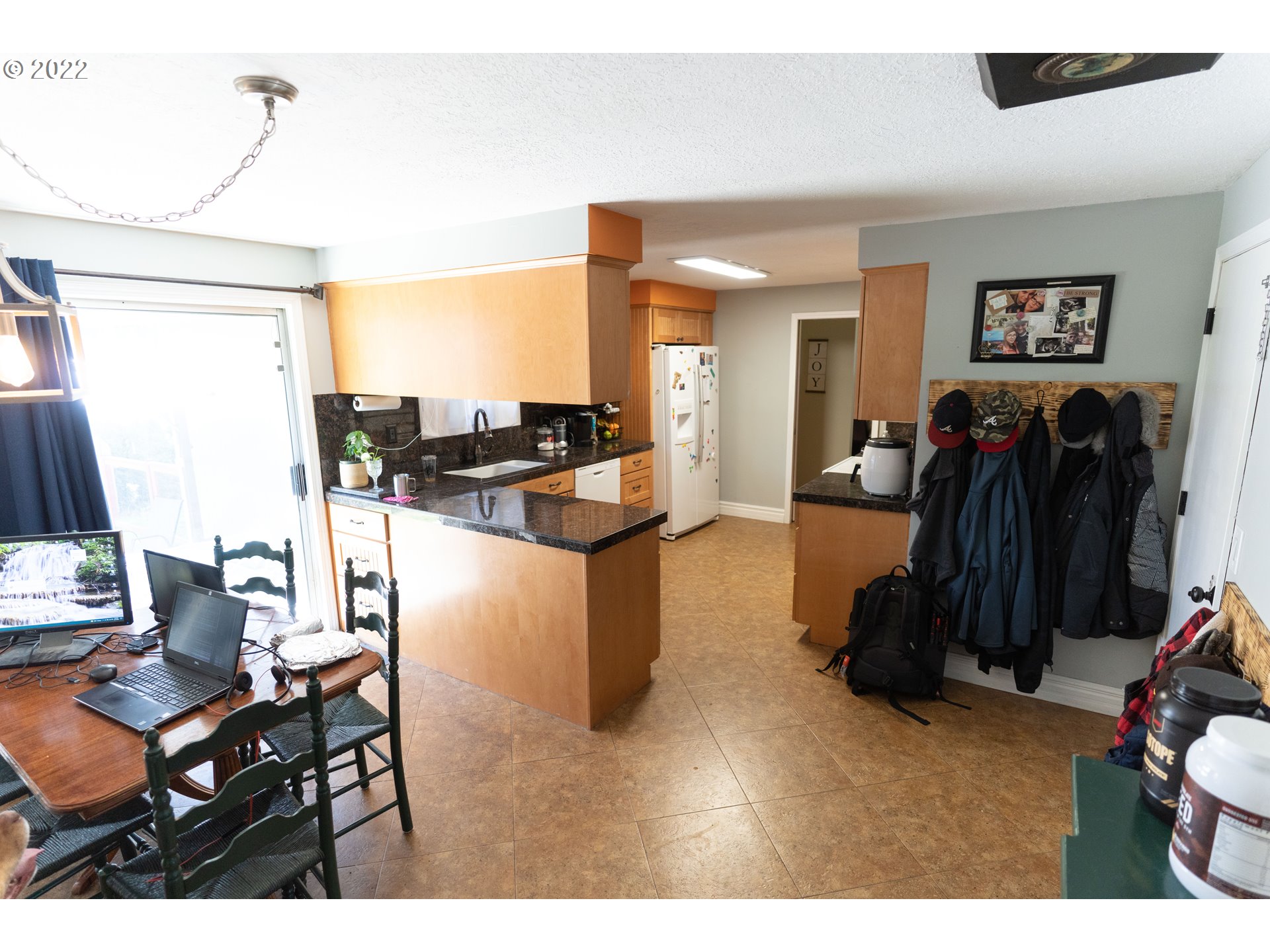 39400 Idleman Street Sandy, OR 97055 - Photo 3 of 15 a living room with furniture a flat screen tv and a refrigerator