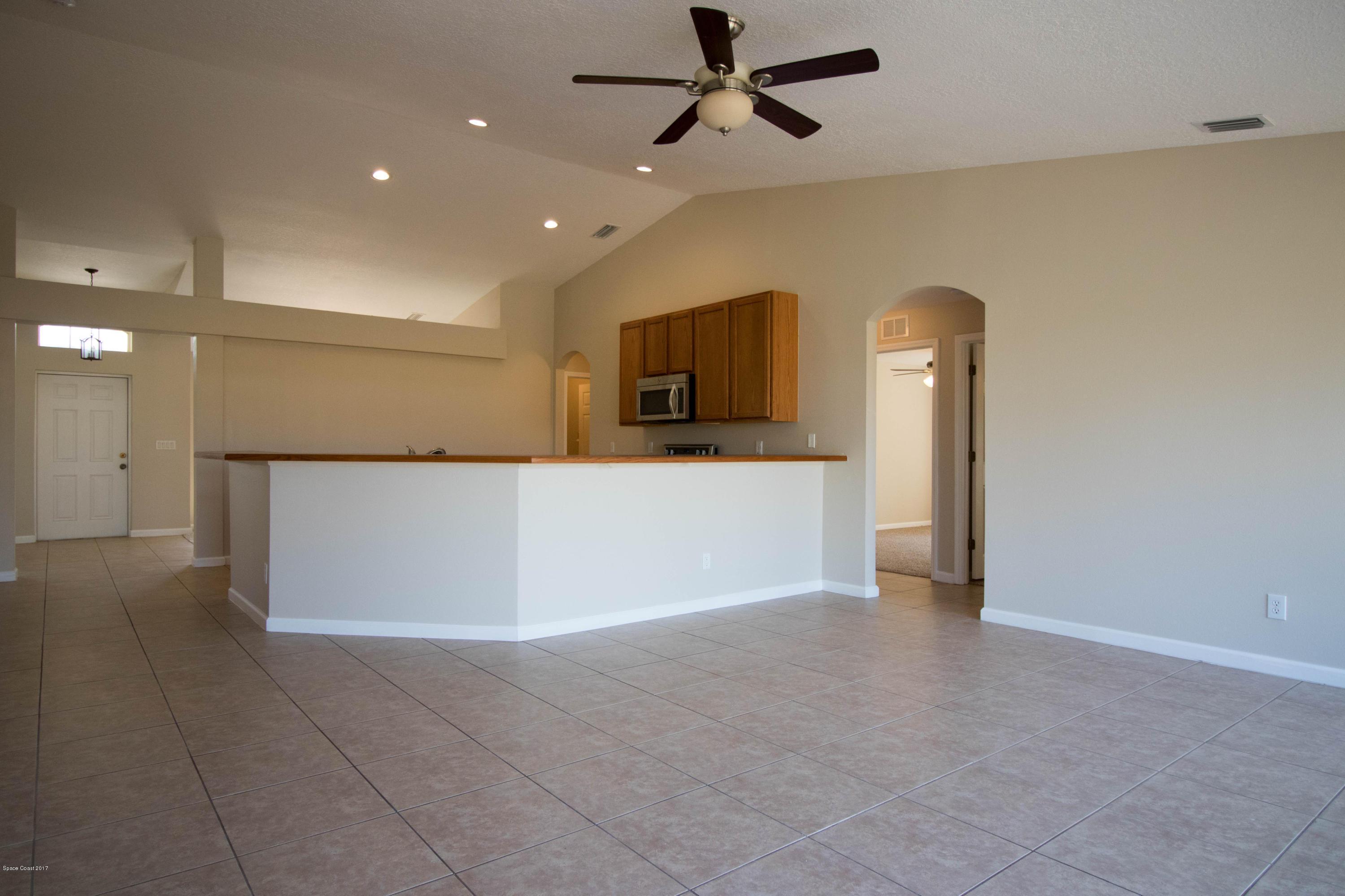 515 Nackman Road Northwest Palm Bay, FL 32907 - Photo 5 of 16 Family Room & Kitchen
