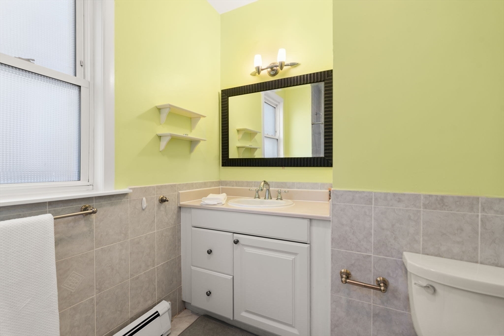 39 Lothrop Street, Unit 1 Boston, MA 02135 - Photo 11 of 19 a bathroom with a toilet sink and mirror