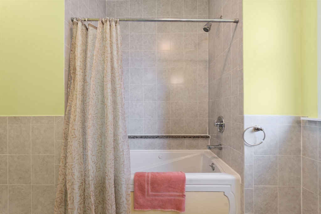 39 Lothrop Street, Unit 1 Boston, MA 02135 - Photo 12 of 19 a bathroom with a tub and a shower curtain