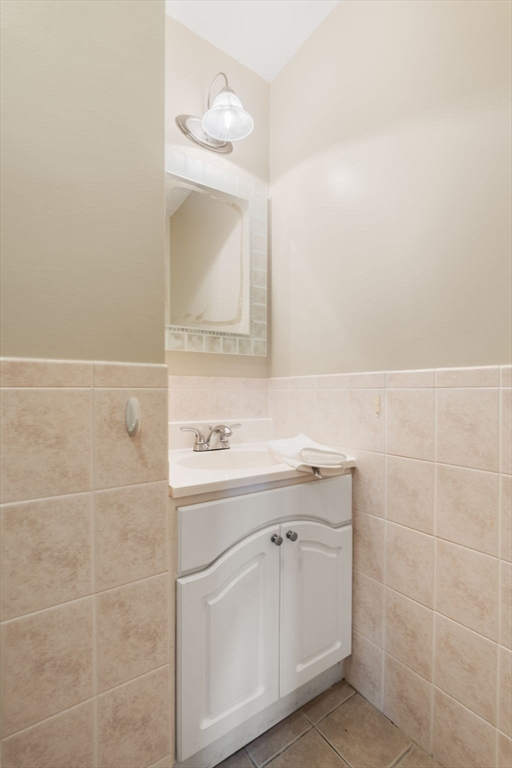 39 Lothrop Street, Unit 1 Boston, MA 02135 - Photo 14 of 19 a bathroom with a sink a vanity and a mirror