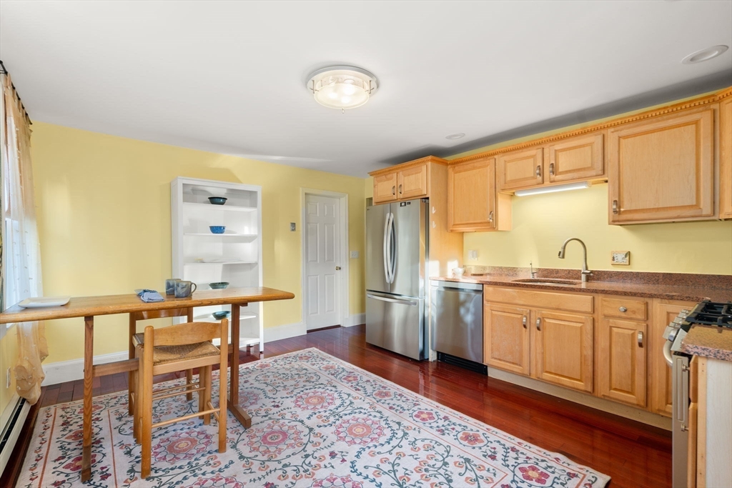 39 Lothrop Street, Unit 1 Boston, MA 02135 - Photo 6 of 19 a large kitchen with a table and chairs in it