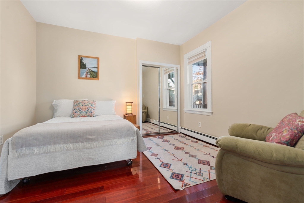 39 Lothrop Street, Unit 1 Boston, MA 02135 - Photo 9 of 19 a bedroom with a bed couch and window