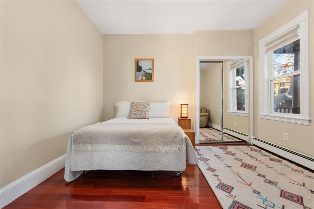 39 Lothrop Street, Unit 1 Boston, MA 02135 - Photo 10 of 19 a bedroom with a bed and wooden floor