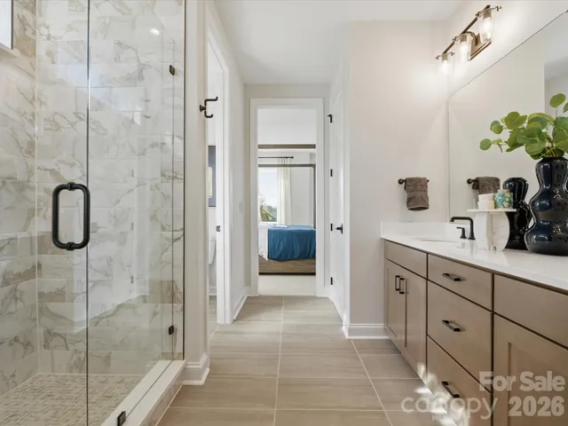 a bathroom with a shower sink and mirror