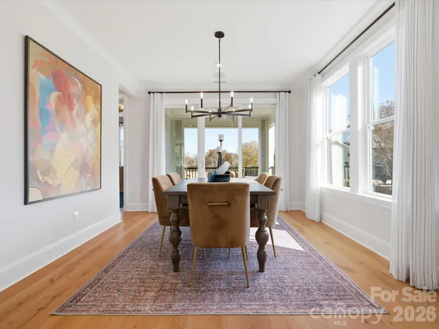 a dining room with wooden floor and window