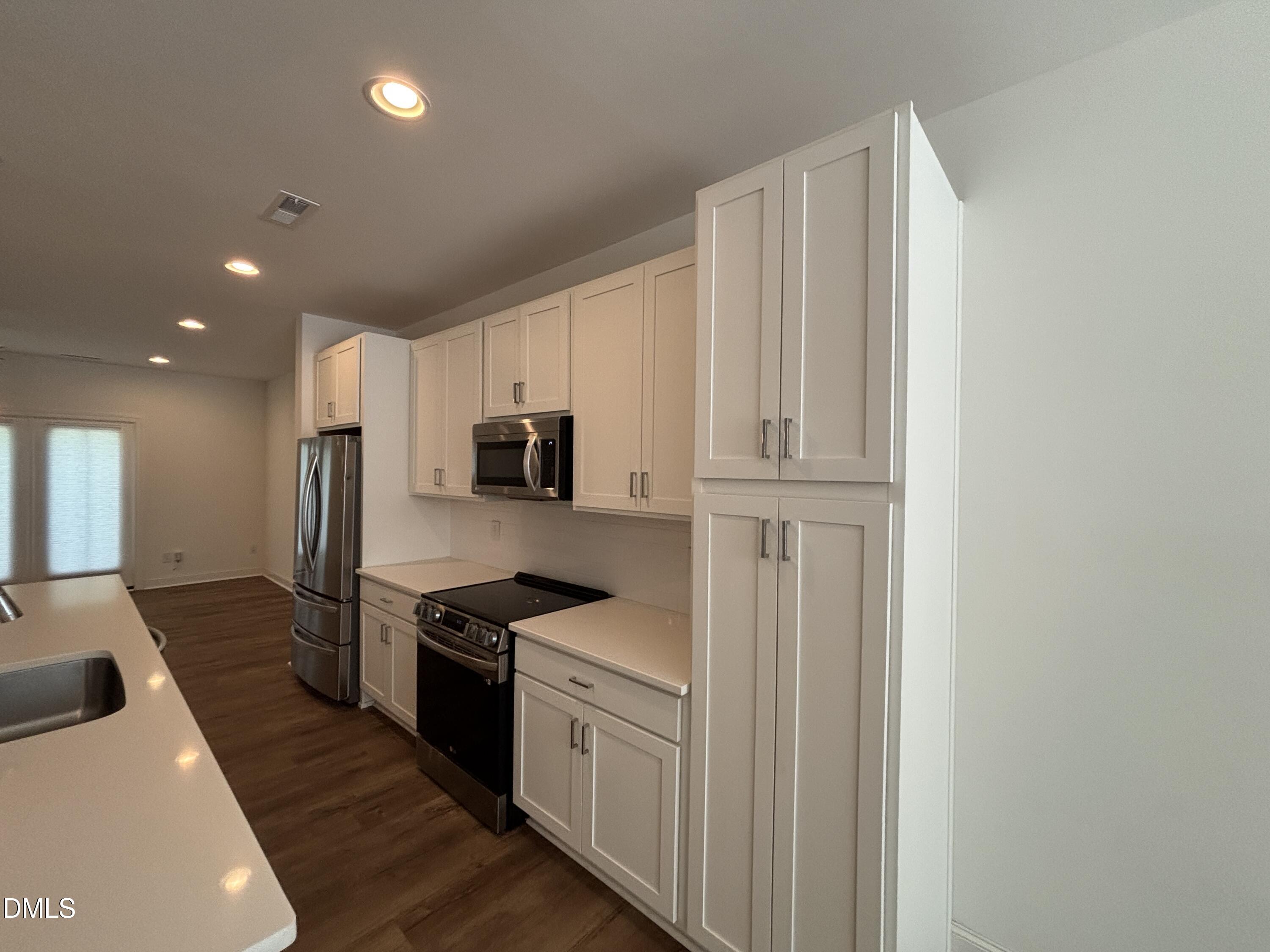 5710 Parker Pnes Court Raleigh, NC 27609 - Photo 18 of 78 a kitchen with stainless steel appliances granite countertop a refrigerator and a stove top oven