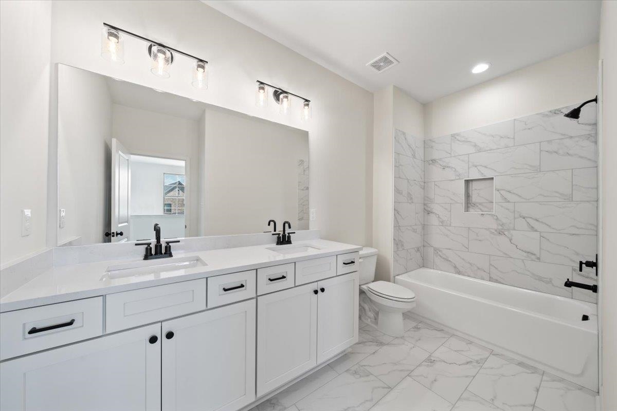 467 Armel Drive Collierville, TN 38017 - Photo 21 of 37 a bathroom with a double vanity sink mirror toilet and bathtub