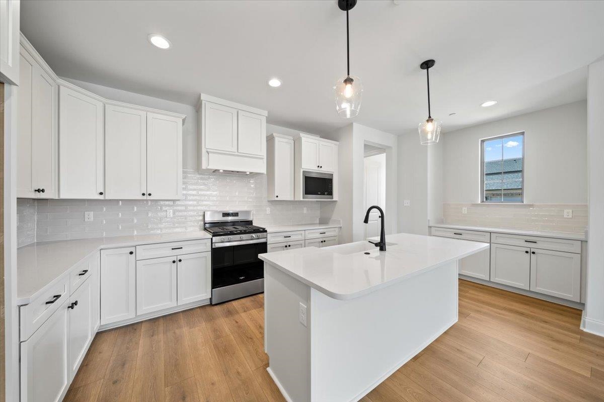 467 Armel Drive Collierville, TN 38017 - Photo 8 of 37 a kitchen with white cabinets appliances and sink
